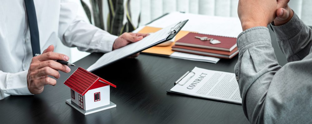 Estate agent are presenting home loan to client and discussing to decision signing agreement contract form, Home Insurance and Real estate investment concept.
