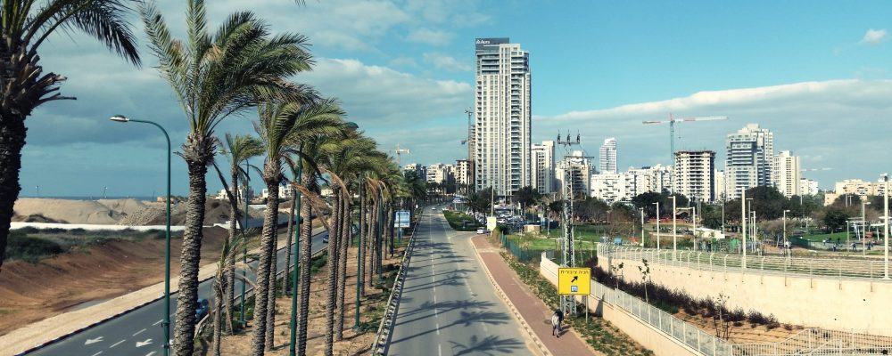 road-by-city-against-sky